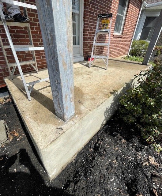 Weathered porch slab and post before refinishing