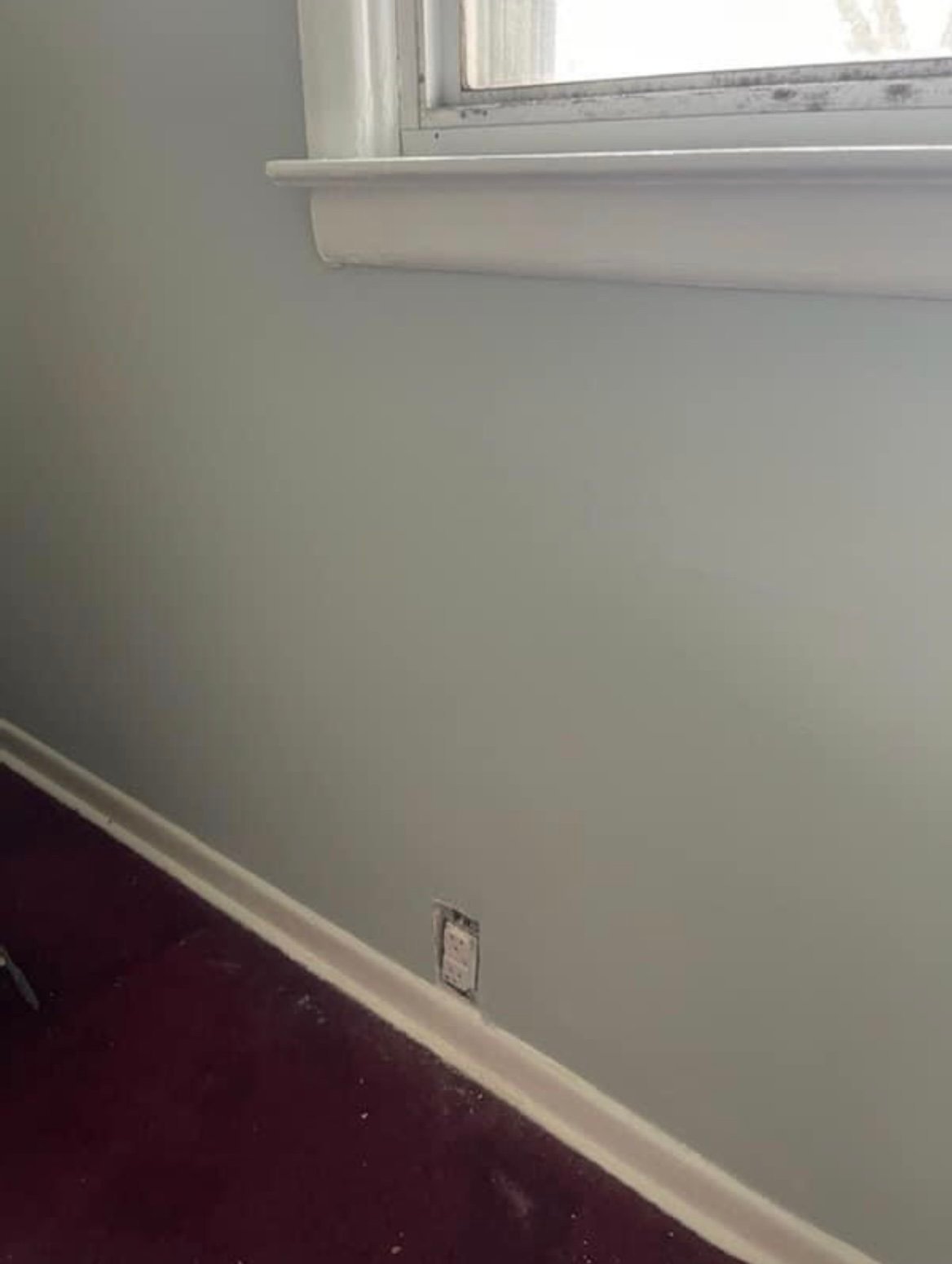 A water-damaged wall after RFCP repaired and repainted it in a fresh gray-green