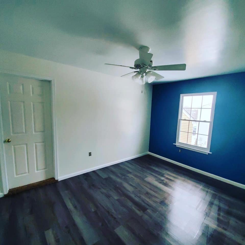 Bedroom with a navy accent wall and crisp white trim
