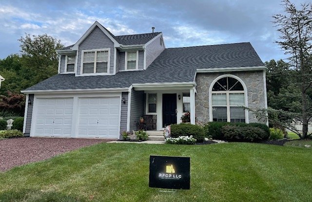 Finished two-story home exterior with an RFCP yard sign