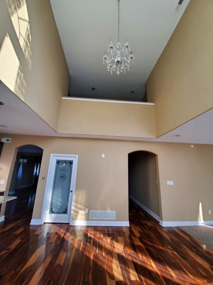 Two-story foyer with a vaulted accent ceiling and crystal chandelier