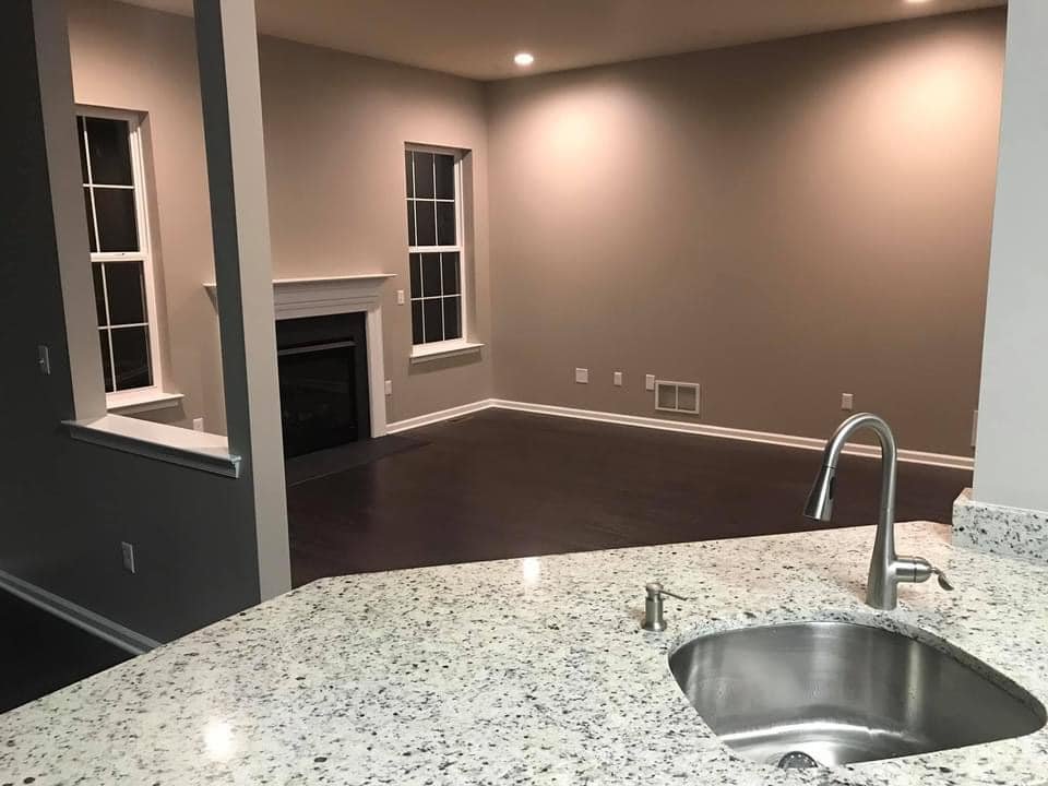 Open great room and kitchen with warm taupe walls
