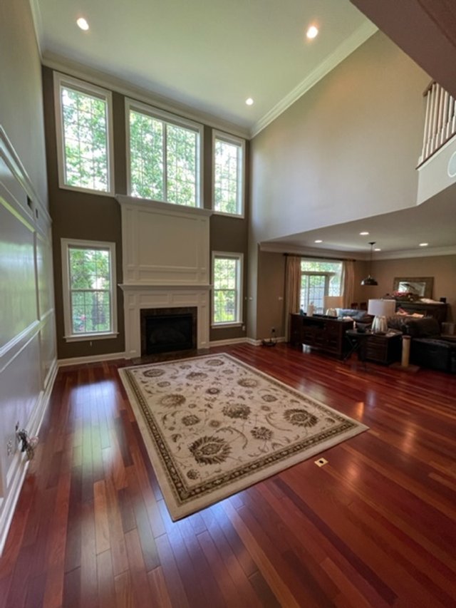 Two-story great room with fireplace and tall windows