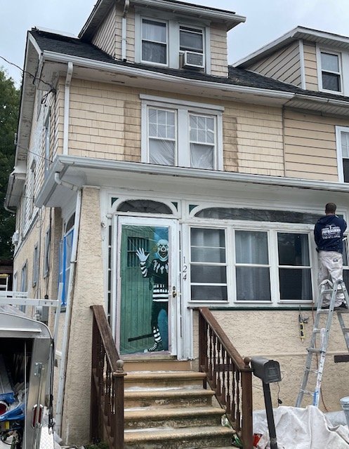 RFCP crew on a ladder prepping a worn exterior